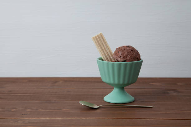 chocolate ice cream with wafer on dessert cup isolated on table