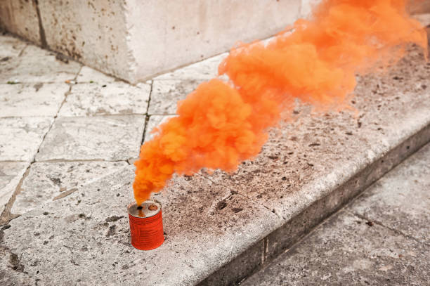 istock Orange smoke can on stony ground 2156070891