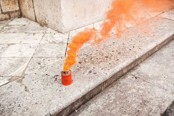 istock Orange smoke can on stony ground 2156070918