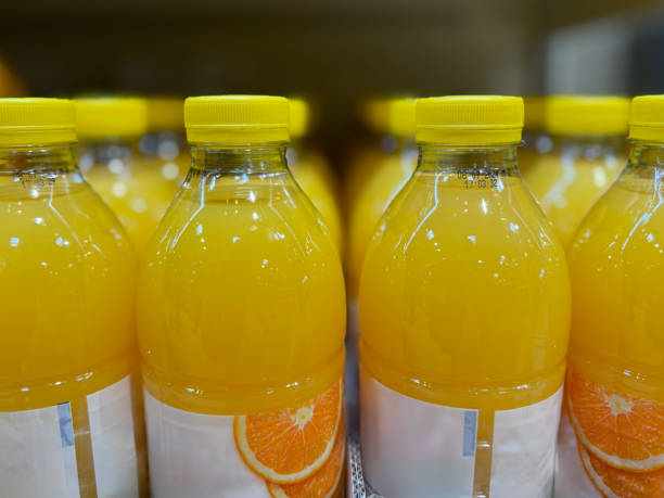 istock Orange Juice Bottles on Shelf 2156071116