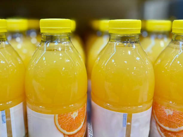 istock Orange Juice Bottles on Shelf 2156071117