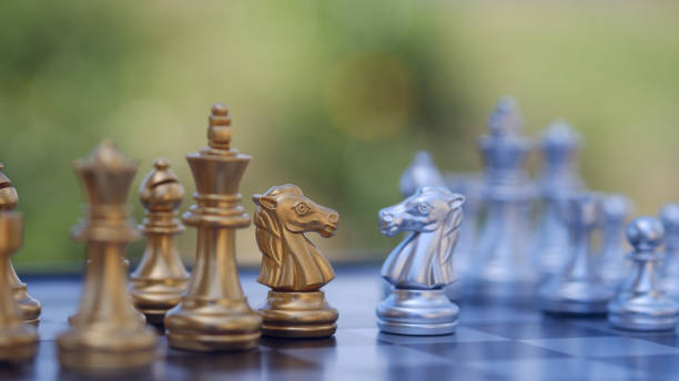 istock gold  knight Against whithe background, International chess, ideas and competition and strategy, chess board game competition business concept. 2156071271