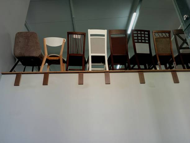 Modern chairs on the window of a furniture store. Industry