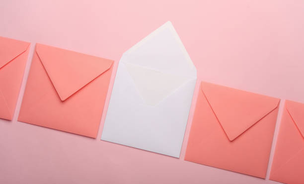 istock Square paper pink and white envelopes on pink background 2156072989