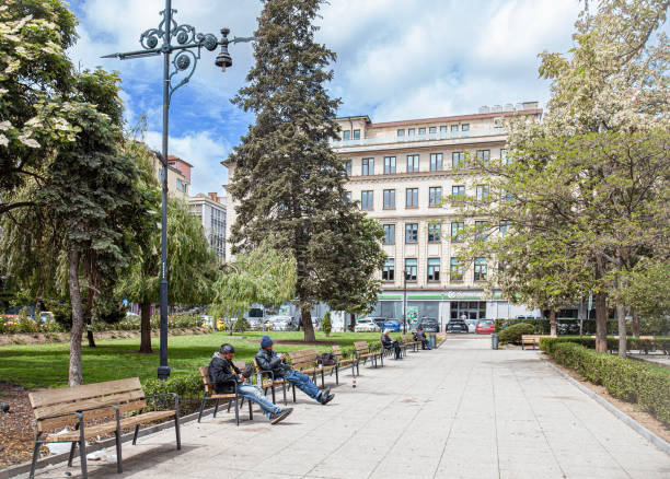 People sitting and relaxing in the Rabbi Gavriel Mercado Almosnino garden in central Sofia, Bulgaria