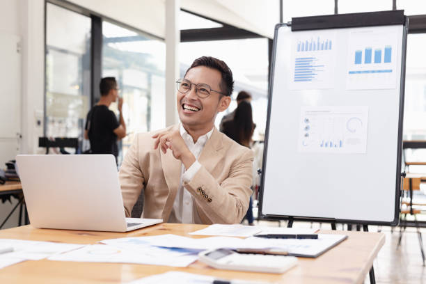 istock Businessman with laptop and analyzing a chart on a laptop while working in the office. 2156074236