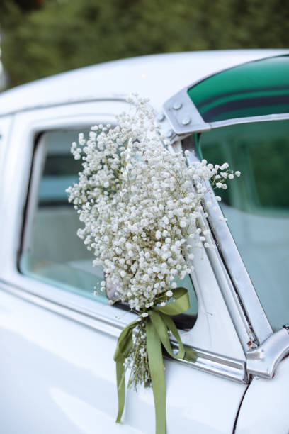 Floral ornaments on a vintage white wedding car