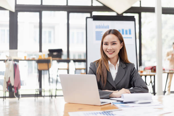 istock Businesswoman with laptop and analyzing a chart on a laptop while working in the office. 2156074269