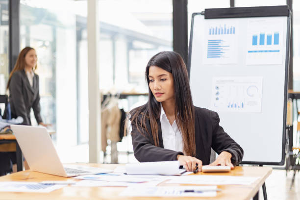 istock Businesswoman with laptop and analyzing a chart on a laptop while working in the office. 2156074292