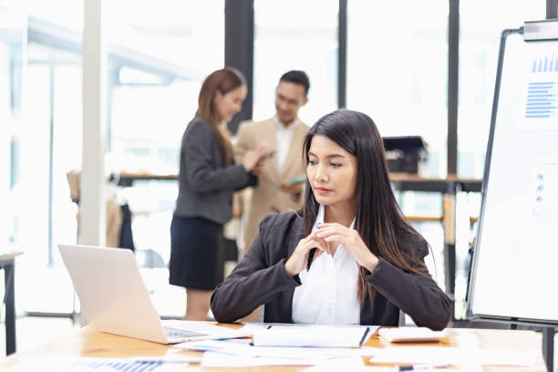 istock Businesswoman with laptop and analyzing a chart on a laptop while working in the office. 2156074299