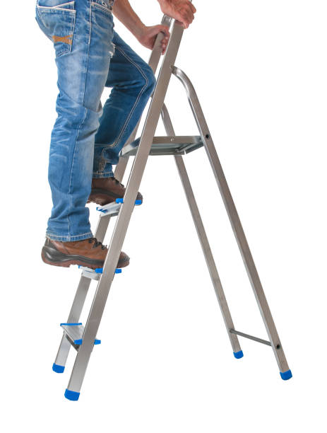 istock Handyman climbing on a ladder isolated on  white background 2156074375