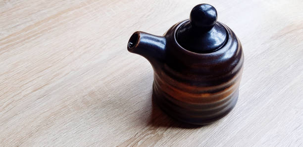 istock Black ceramic jug or mug tea putting on the wooden table with copy space. Single object, Dishware in Japanese style, Design and Container 2156075614