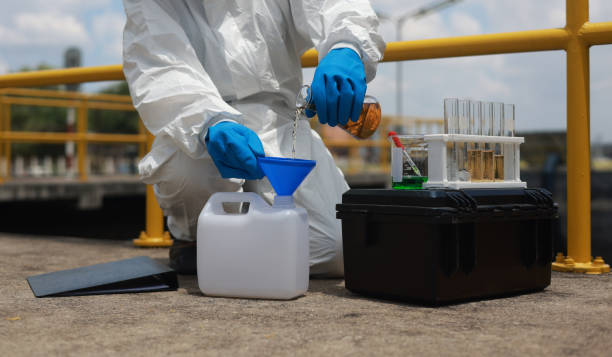 istock Scientists biologists or researchers in protective suits taking water samples from wastewater from industries. Experts analyze the water in a contaminated environment. 2156075660