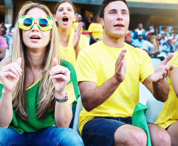 istock Soccer fans sitting in a stadium react as they watch the big match 2156076344