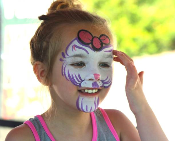 istock Five-Year-Old Girl Looking Happy After Face Paint Application 2156076830