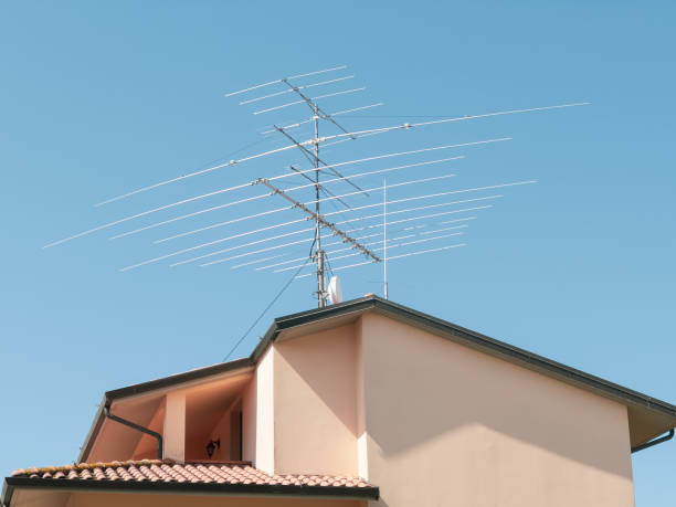 Low Angle View Of A Television Antenna against a blue sky.antenna
