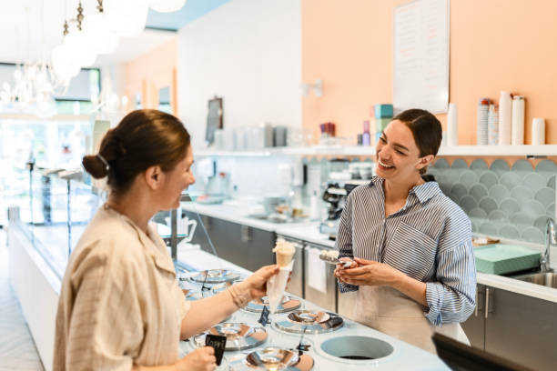 istock Young Woman Enjoys Purchasing Her Favorite Ice Cream 2156079324