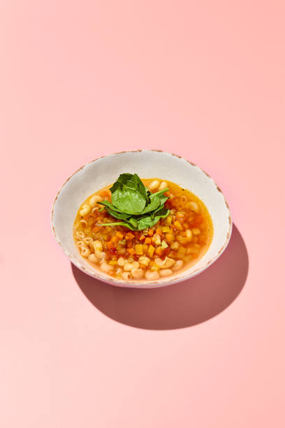 istock Gluten-Free Vegetable Minestrone Soup with Pasta on Pink Background 2156079697