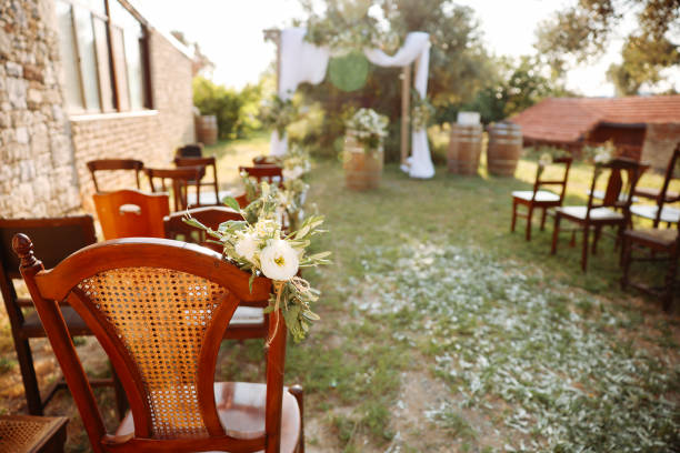 Romantic wedding ceremony. Beautiful setting for outdoors wedding ceremony waiting for bride and groom and guests. Decoration