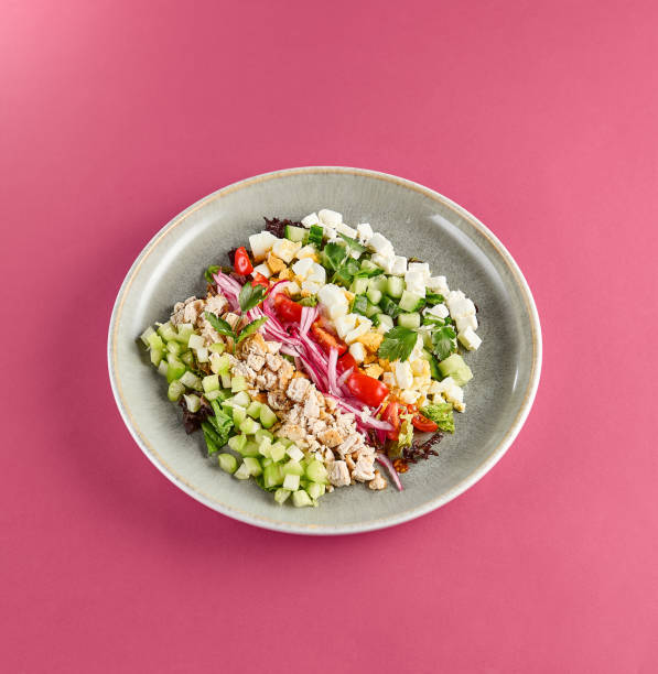 istock Fresh and Colorful Cobb Salad on Pink Background 2156081258