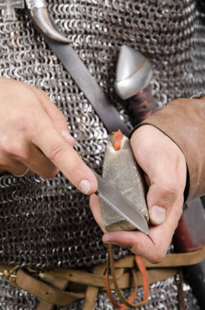 istock Norman warrior 2nd half of the 11th century sharpens knife 2156082941