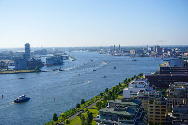 istock High angle view of buildings by river against clear sky 2156083173