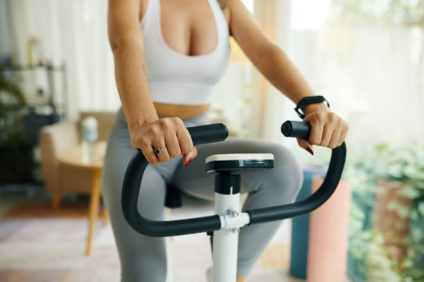 istock Hands on Handlebars of Exercise Bike 2156083765