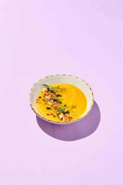istock Gourmet Pumpkin Cream Soup with Shrimp on Light Pink Background 2156085507