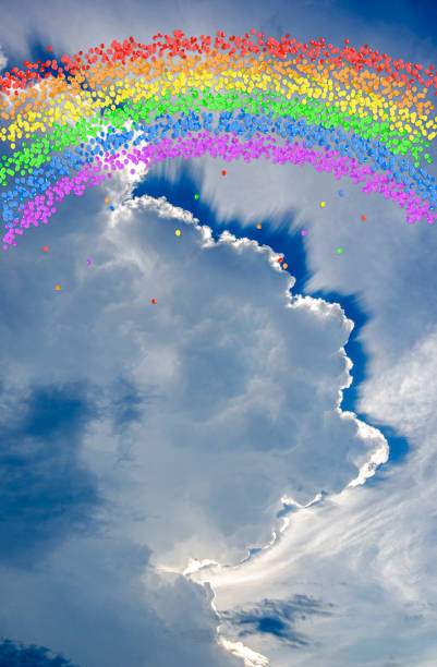 Thousands of multi-colored balloons float toward the sky to create a Pride Rainbow Flag