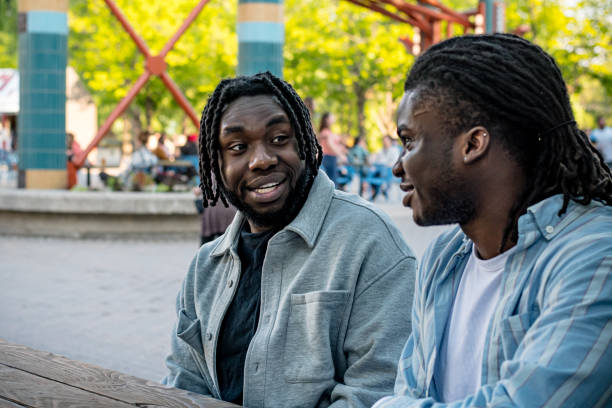 istock Lively Downtown Gathering: Young Black Men Chat in Bustling Downtown Winnipeg 2156090877