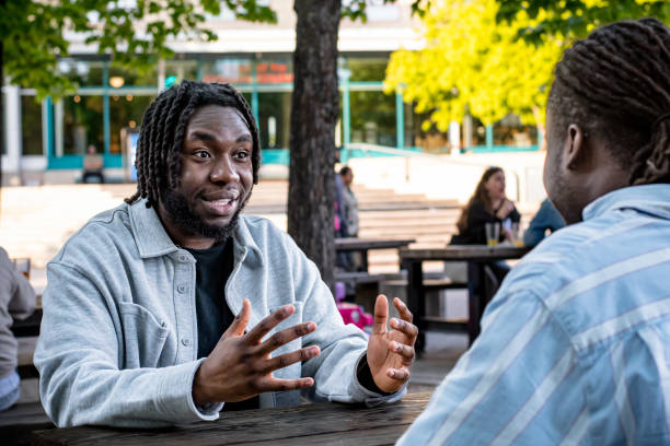 istock Lively Downtown Gathering: Young Black Men Chat in Bustling Downtown Winnipeg 2156090879