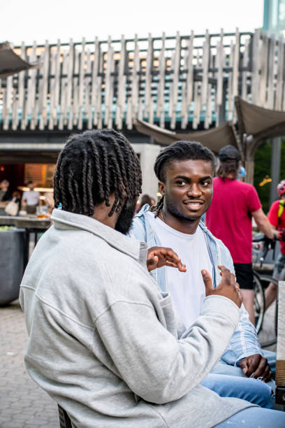 istock Lively Downtown Gathering: Young Black Men Chat in Bustling Downtown Winnipeg 2156090881