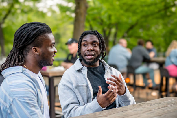 Lively Downtown Gathering: Young Black Men Chat in Bustling Downtown Winnipeg