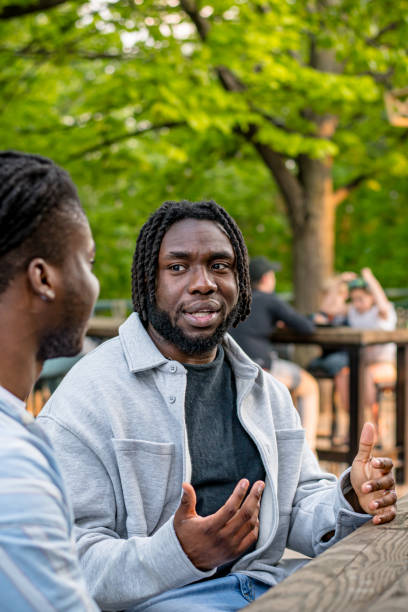 istock Lively Downtown Gathering: Young Black Men Chat in Bustling Downtown Winnipeg 2156090888