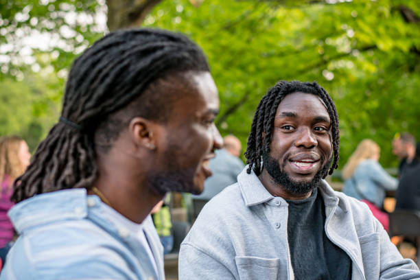 istock Lively Downtown Gathering: Young Black Men Chat in Bustling Downtown Winnipeg 2156090889