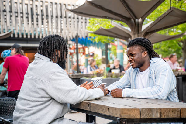 istock Lively Downtown Gathering: Young Black Men Chat in Bustling Downtown Winnipeg 2156090891
