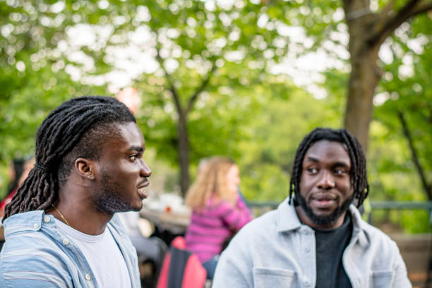 istock Lively Downtown Gathering: Young Black Men Chat in Bustling Downtown Winnipeg 2156090893