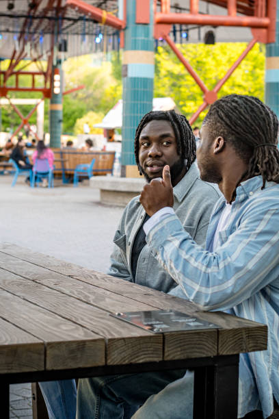 istock Lively Downtown Gathering: Young Black Men Chat in Bustling Downtown Winnipeg 2156090906