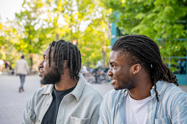 istock Lively Downtown Gathering: Young Black Men Chat in Bustling Downtown Winnipeg 2156092420