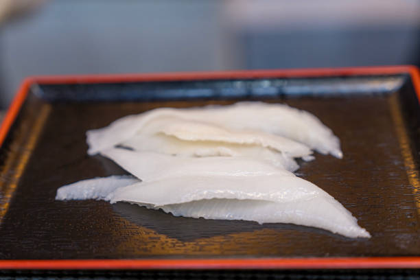 Engawa (fin of flatfish). grabbing sashimi, raw fish cut thinly. Japanese food.