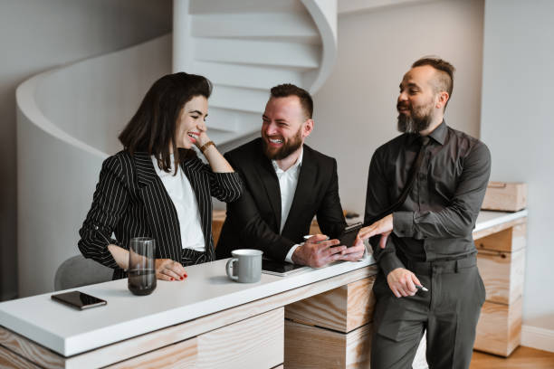 istock Business People Watching Funny Images On Smartphone During Work Break 2156101401