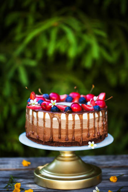istock Delicious homemade Three chocolate mousse cake decorated with fresh berries 2156101771
