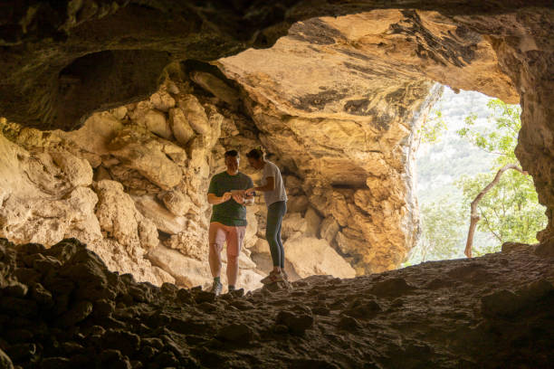 istock Couple look at phone together in cave 2156103810