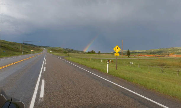 Scenic view driving road towards rainbow, Southern Alberta