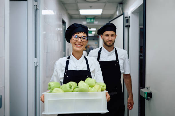 istock Happy female chef with fresh groceries looking at camera. 2156105410