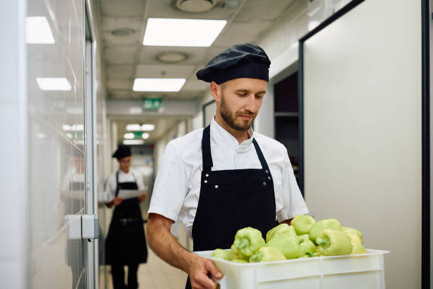 istock Male cook carrying fresh vegetables from the pantry. 2156105425