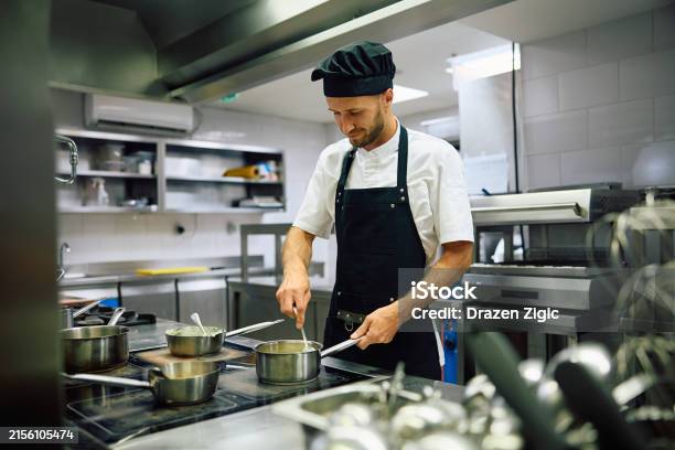Working Condition Cook Smiling Cook Preparing A Dish While Working In Restaurant Kitchen Stock ...
