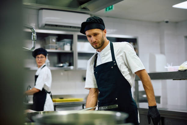 istock Professional chef working in the kitchen in a restaurant. 2156105558