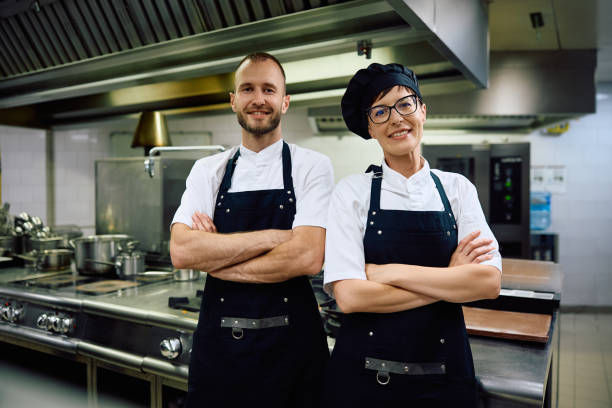 istock Portrait of confident chefs in the kitchen in restaurant looking at camera. 2156105657