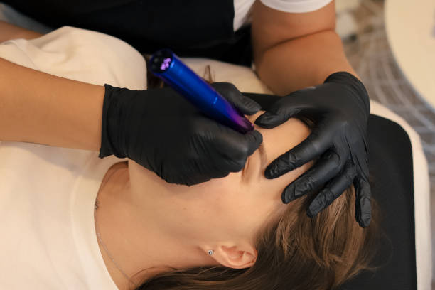 istock procedure of permanent makeup in tattoo salon 2156105913